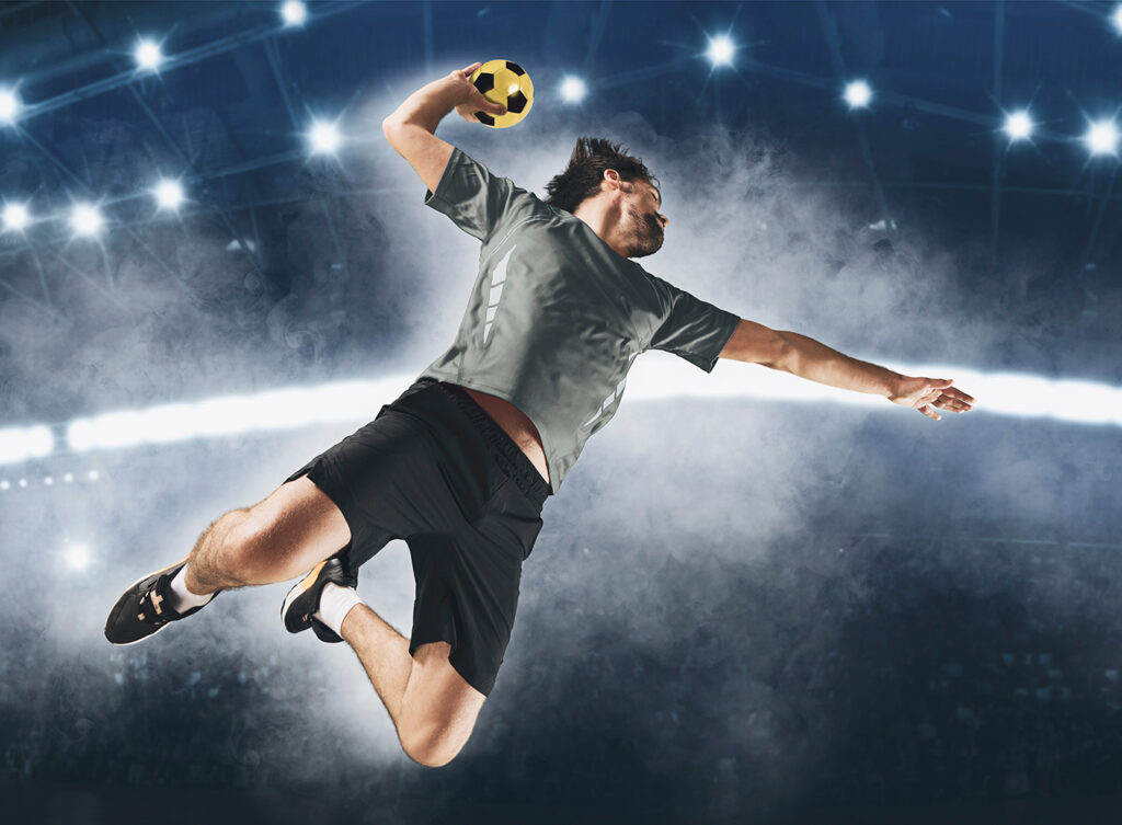 Caucasian young handball player in action. Concept of sport, movement, energy, dynamic, healthy lifestyle